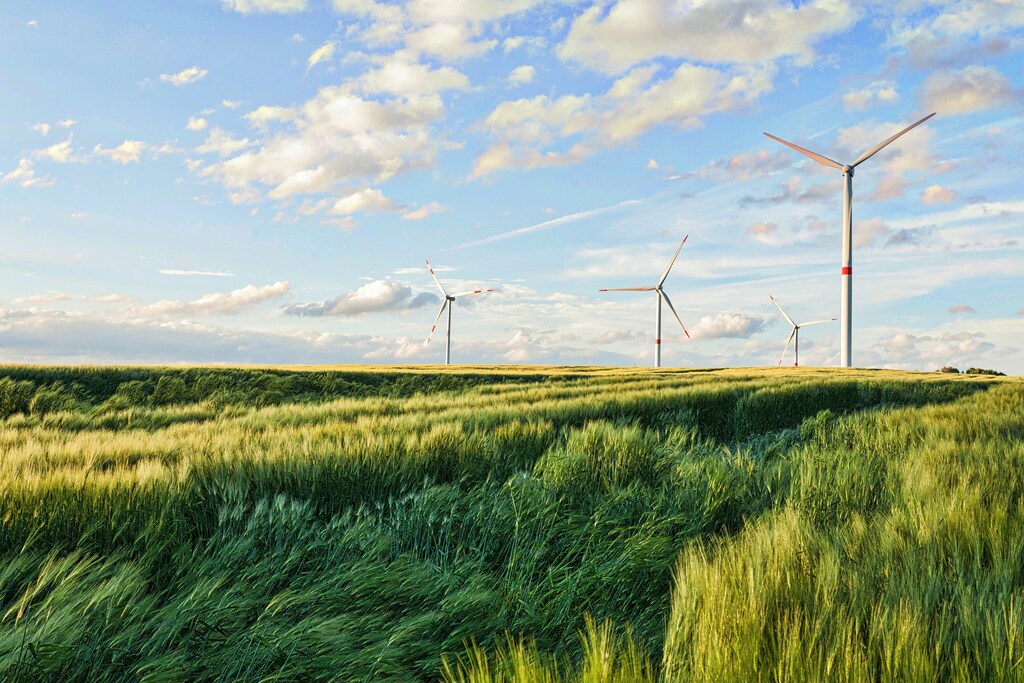 A beautiful shot of wind turbines under the cloudy sky.