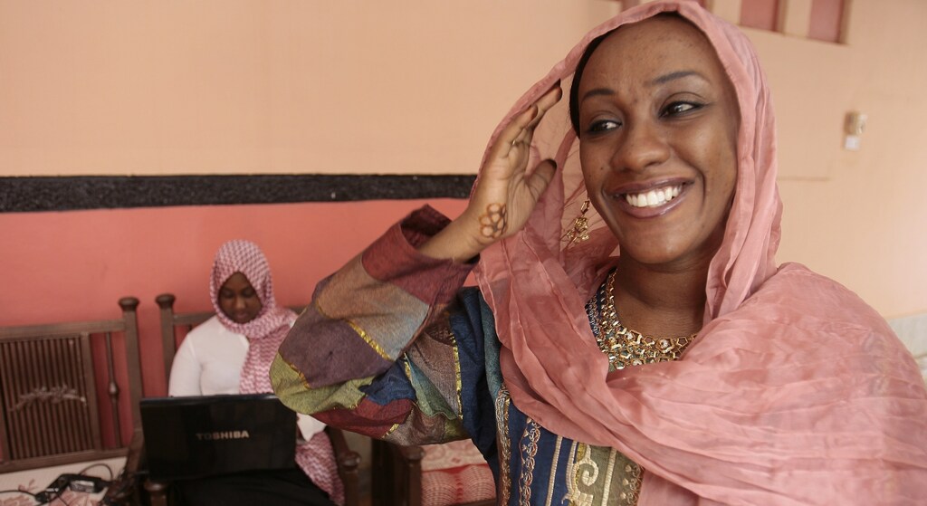 Shiraz Al-Tayeb Hamid (R), 28, managing director of her family's plastic factory, smiles at her house in Khartoum February 27, 2009.