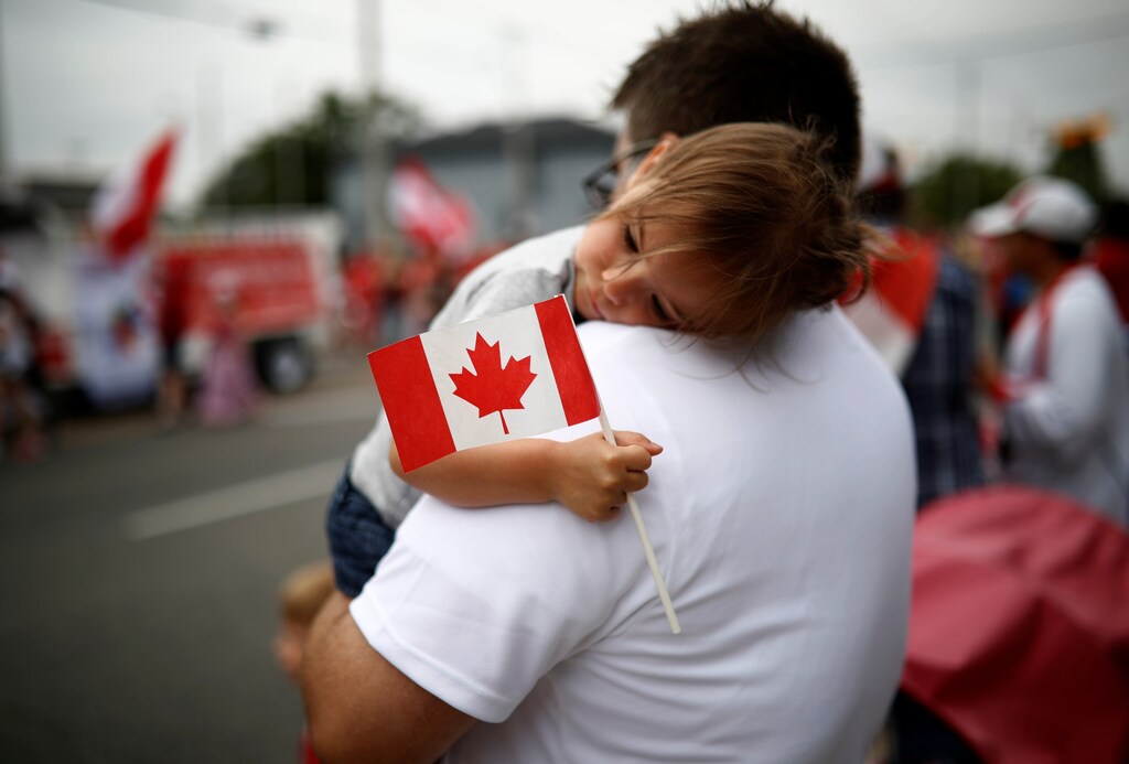 Emery Litynsky, 2, holds a Canadian flag during the East York Toronto Canada Day parade, as the country marks its 150th anniversary with "Canada 150" celebrations, in Toronto, Ontario, Canada July 1, 2017. REUTERS/Mark Blinch - RTS19E0G