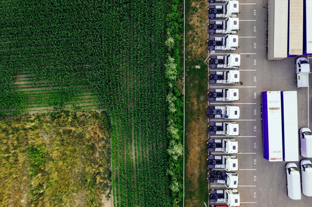 Trucks parked next to a field.