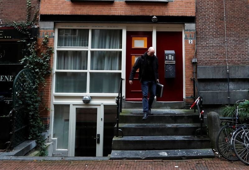 A man leaves a property in central Amsterdam, Netherlands, December 1, 2017. REUTERS/Yves Herman - RC1213FB9CE0