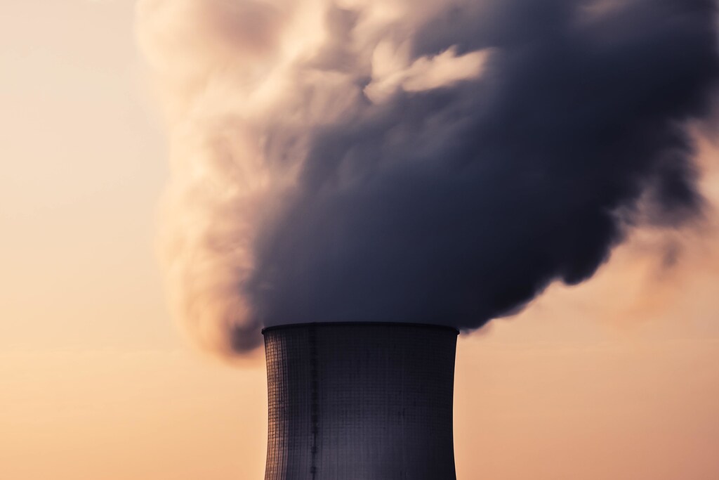Nuclear power plant cooling tower emitting fumes.