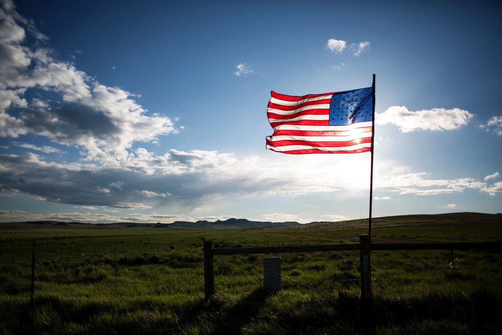 An American flag is seen along Wyoming Highway 59 near a residential housing development south of Gillette, Wyoming, U.S. May 31, 2016. REUTERS/Kristina Barker - RTSXKMM