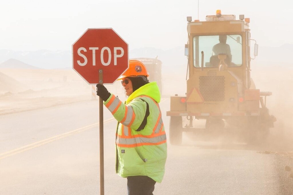 A flagger controls traffic on a Montana highway rebuild project.