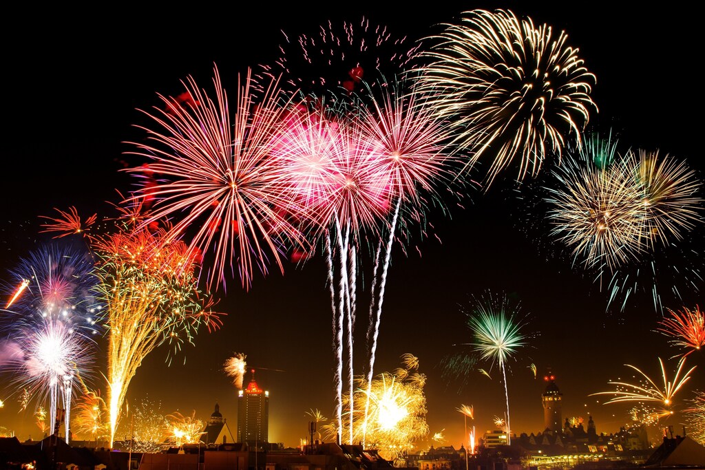 Fireworks burst across a night sky