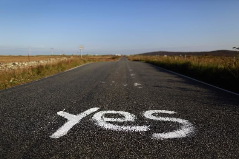 Graffiti supporting the "Yes" campaign is painted on a road in North Uist in the Outer Hebrides September 17, 2014. The referendum on Scottish independence will take place on September 18, when Scotland will vote whether or not to end the 307-year-old union with the rest of the United Kingdom. REUTERS/Cathal McNaughton (BRITAIN - Tags: POLITICS ELECTIONS) - GM1EA9I00IO01