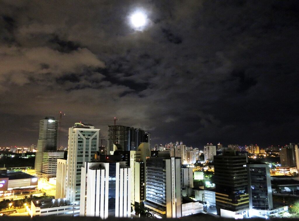 The moon rises above buildings in Salvador, Brazil December 4, 2012. Salvador, the third-largest city in Brazil is the country's oldest metropolis, but has a lower profile than party hot spot Rio de Janiero or the commercial nerve, Sao Paulo. The laid back coastal city, which lies on the All Saints Bay on the Atlantic Ocean, is the heart of Bahia, the Brazilian province know for its rich African culture. Salvador is gearing up for an influx of sports fans, since it has been chosen as one of Brazil's 12 host cities for the FIFA World Cup in 2014. Picture taken December 4, 2012. To match TRAVEL-SALVADOR/ REUTERS/Gary Hershorn (BRAZIL - Tags: CITYSCAPE TRAVEL SOCIETY) - RTR3DTJO
