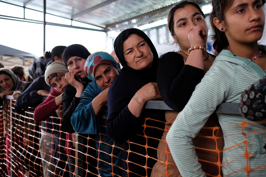 Women queue to receive free clothes at a makeshift camp for refugees and migrants at the Greek-Macedonian border near the village of Idomeni, Greece, May 12, 2016. REUTERS/Marko Djurica - D1AETDPEDHAA