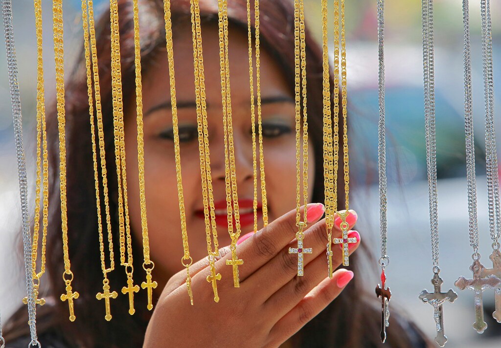 A woman looks at crosses for sale on display outside a church in Chandigarh, India, April 1, 2018. REUTERS/Ajay Verma