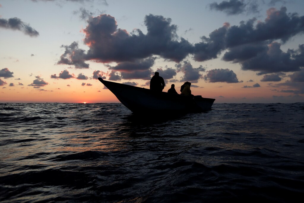 Libyan migrants on a wooden boat await rescue by the migrant search and rescue vessel MV Seefuchs of the German NGO Sea-Eye in the search and rescue zone some fifty nautical miles north of the Tunisian-Libyan land border, September 30, 2017. REUTERS/Darrin Zammit Lupi - RC1AED6D7160