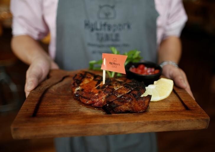 A staff member prepares to serve a pork steak at HyLife Pork Table, a pork dish restaurant operated by Canadian pig farmer and pork processor HyLife, at Daikanyama district in Tokyo, Japan October 31, 2016. Picture taken October 31, 2016. REUTERS/Issei Kato