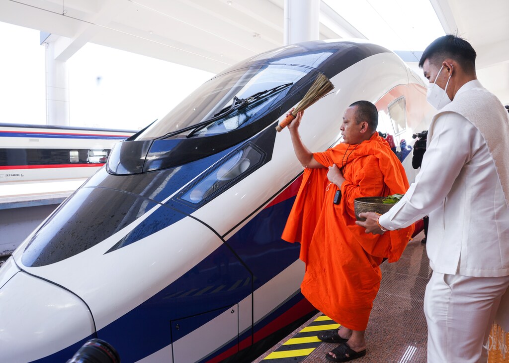 A monk blesses a train during a Buddhist ceremony one day prior to the handover ceremony of the high-speed rail project linking the Chinese southwestern city of Kunming with Vientiane, in Vientiane, Laos, December 2, 2021. REUTERS/Phoonsab Thevongsa
