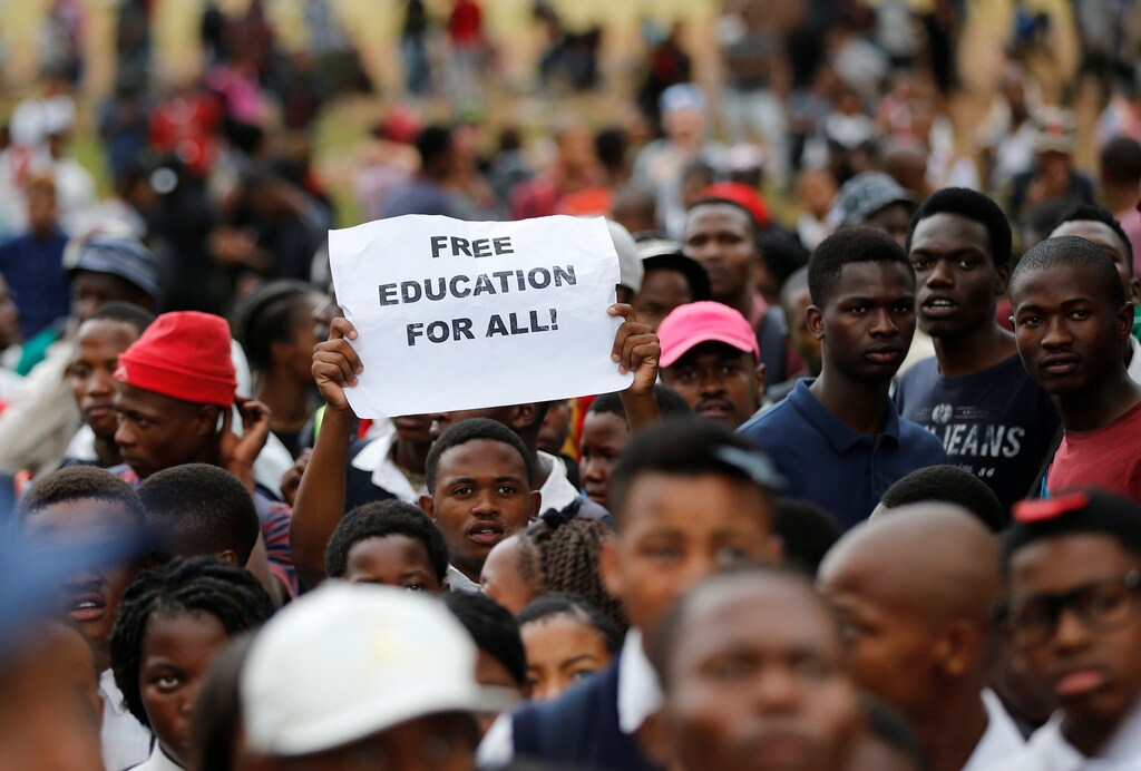 A protester holds up a placard as students gather outside South African President Jacob Zuma's offices demanding free university education, in Pretoria, South Africa October 20,2016. REUTERS/Siphiwe Sibeko - RTX2PQ00