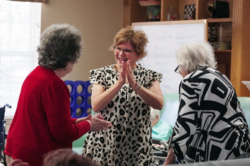 Activities director Amber Brown, dances with memory care patients at the Ave Maria Home, an assisted living center for seniors, in Bartlett, Tennessee, U.S., September 19, 2023. REUTERS/Karen Pulfer Focht