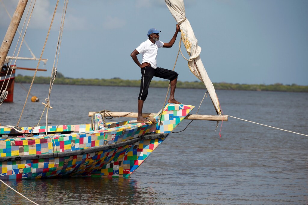 A man stands on the front of Flipflopi the first dhow boat made entirely of recycled plastic during its launch ceremony on the island of Lamu, Kenya, September 15, 2018. REUTERS/Baz Ratner - RC185C961100