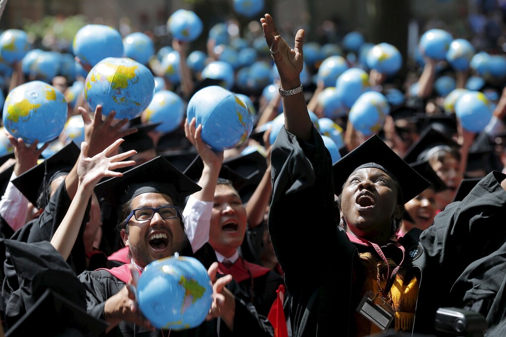 Olufunke Michaels (R) and her classmates celebrate after receiving their degrees from the John F. Kennedy School of Government during the 364th Commencement Exercises at Harvard University in Cambridge, Massachusetts May 28, 2015. REUTERS/Brian Snyder TPX IMAGES OF THE DAY - GF10000110401