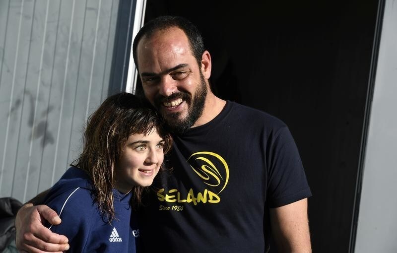 Carmen Lopez Garcia, Spain's first blind female surfer who is to participate in the ISA World Adaptive Surfing Championship, poses with her coach Lucas Garcia after training at Salinas beach, Spain, December 5, 2018. Picture taken December 5, 2018. REUTERS/Eloy Alonso - RC1B7C901600
