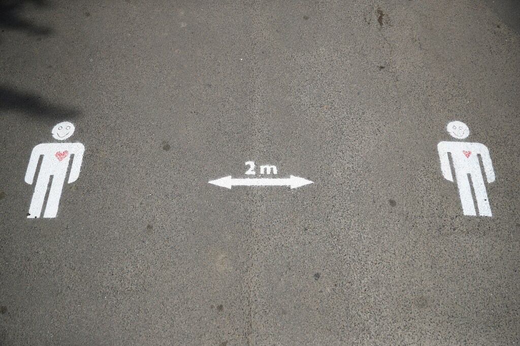 A notice on the pavement reminding people of social distancing in Tooting, following the outbreak of the coronavirus disease (COVID-19), London