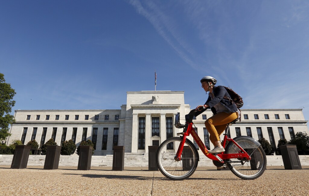 A cyclist passes the Federal Reserve headquarters in Washington September 16, 2015.