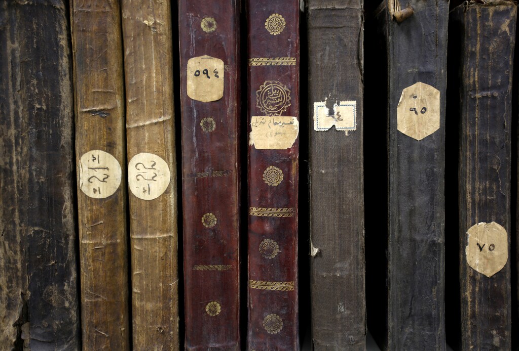 Old books are seen on a shelf in Gazi Husrev-bey library in Sarajevo, January 16, 2014. When Bosnia's National Library went up in flames in 1992 in a bombardment during the Bosnian Serb siege of Sarajevo, Mustafa Jahic knew he had to act to save his own institution's priceless collection. As curator of the almost 500-year-old Gazi Husrev Bey Library, Jahic was guardian of a treasure trove of Oriental literature in the heart of Sarajevo, a city under siege during Bosnia's 1992-95 war. The fruit of his and others' efforts will be rewarded next week when a new state-of-the-art library, a stone's throw from the original in the cobbled streets of Sarajevo's historic Bascarsija district, opens its doors. Picture taken January 16, 2014. REUTERS/Dado Ruvic (BOSNIA - Tags: SOCIETY) - RTX17IDW