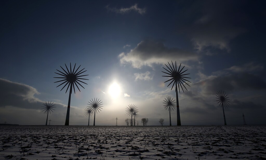Wind turbines are pictured in this multiple exposure at the German village of Feldheim February 21, 2013. Feldheim, a 60-minute drive south of Berlin and home to about 125 people, is Germany's first and only energy self-sufficient village. Germany is a world leader in renewable energy and derives a quarter of its electricity from renewables, but rising prices have turned into a major political issue ahead of the election. Picture taken February 21, 2013. REUTERS/Tobias Schwarz (GERMANY - Tags: POLITICS TPX IMAGES OF THE DAY ENERGY BUSINESS) - RTXXX5Y