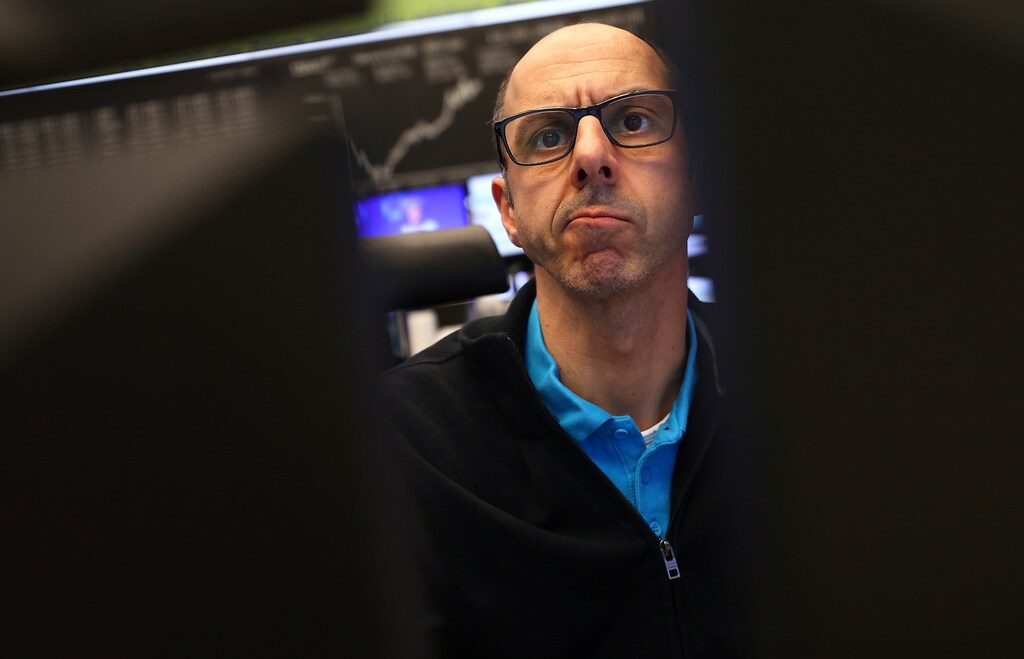 A stock trader looks at his screens during a trading session at Frankfurt's stock exchange in Frankfurt, Germany, March 13, 2020.