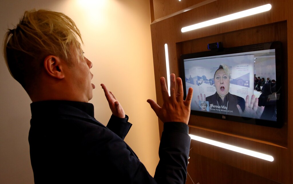 Associate professor of computer science at the University of Southern California Hao Li showcases a 'deepfake' video with Britain's former Prime Minister Theresa May during the 50th World Economic Forum (WEF) annual meeting in Davos, Switzerland, January 22, 2020