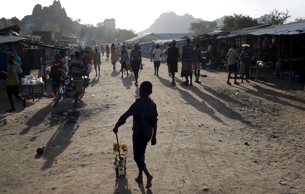 A Karamojong tribe boy plays with a toy decorated with election posters in town of Kaabong in Karamoja region, Uganda February 17, 2016. REUTERS/Goran Tomasevic - GF10000312384