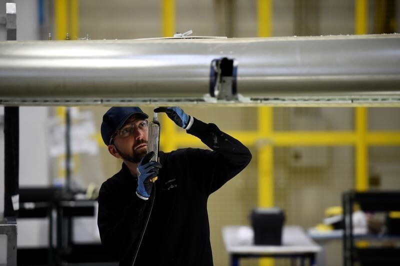 A man works on C Series aeroplane wing in the Bombardier factory in Belfast, Northern Ireland September 26, 2017. REUTERS/Clodagh Kilcoyne - RC1AA983E6A0