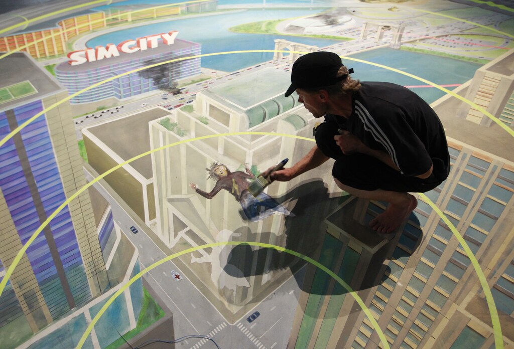 A worker paints at the exhibition stand of "Sim City" during the Gamescom 2012 fair in Cologne August 15, 2012. The Gamescom convention, Europe's largest video games trade fair, runs from August 16 to August 19. REUTERS/Ina Fassbender (GERMANY - Tags: SOCIETY) - BM2E88F1BXZ01