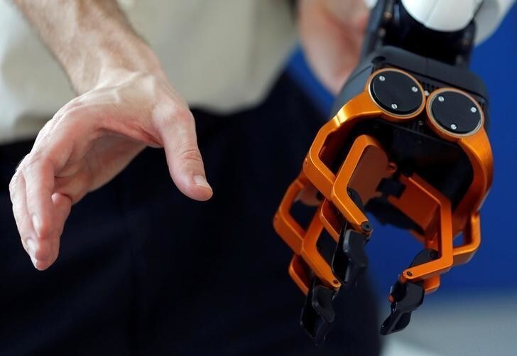 Olivier Stasse, Head of Research at CNRS, tests the hand of Pyrene, a humanoid robot handyman, developped by the French lab Laas (Laboratory for Analysis and Architecture of Systems) of the CNRS in Toulouse, France, February 21, 2017. REUTERS/Regis Duvignau
