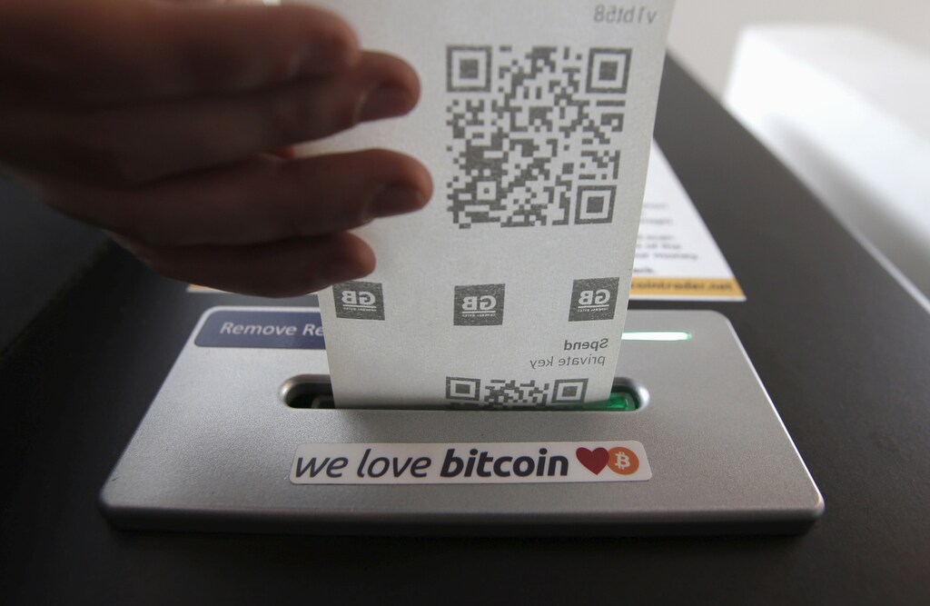 A bitcoin ATM prints out a receipt for a user at the 'Vape Lab' cafe where it is possible to both use and purchase the bitcoin currency, in London March 24, 2015.