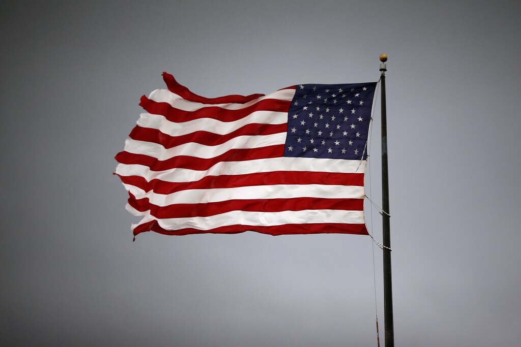 Storm clouds loom over an American flag in Convent, Louisiana, U.S., June 11, 2018. Picture taken June 11, 2018. REUTERS/Jonathan Bachman - RC1C22927710
