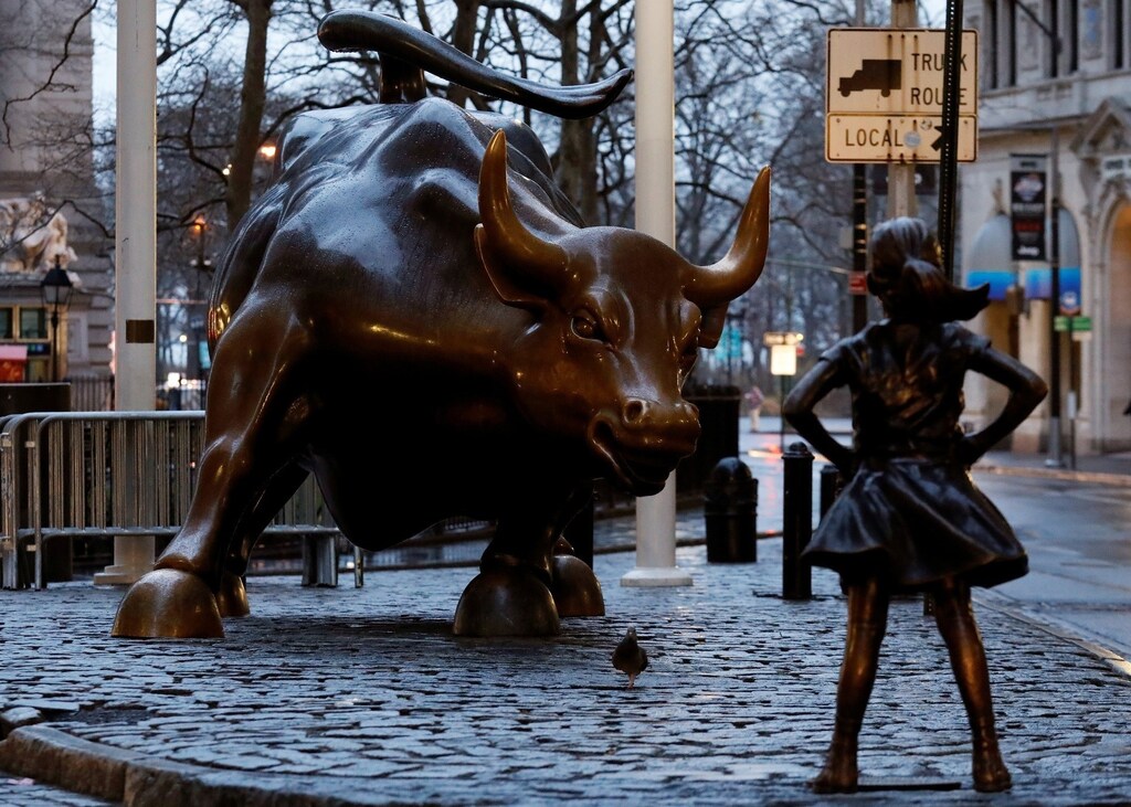 A statue of a girl facing the Wall St. Bull is seen, as part of a campaign by U.S. fund manager State Street to push companies to put women on their boards, in the financial district in New York, U.S., March 7, 2017. REUTERS/Brendan McDermid - RTS11U5N