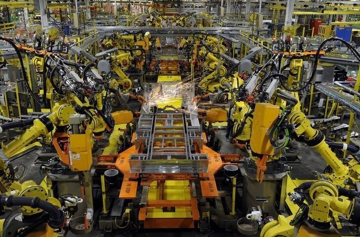 Robotic arms spot welds on the chassis of a Ford Transit Van under assembly at the Ford Claycomo Assembly Plant in Claycomo, Missouri April 30, 2014. REUTERS/Dave Kaup (UNITED STATES - Tags: BUSINESS TRANSPORT)