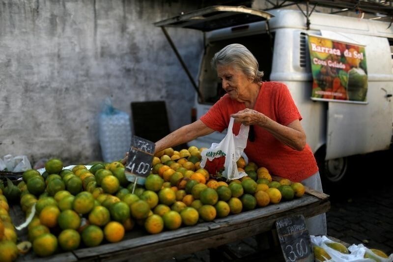 A customer selects oranges at a street market in Rio de Janeiro, Brazil, May 6, 2016