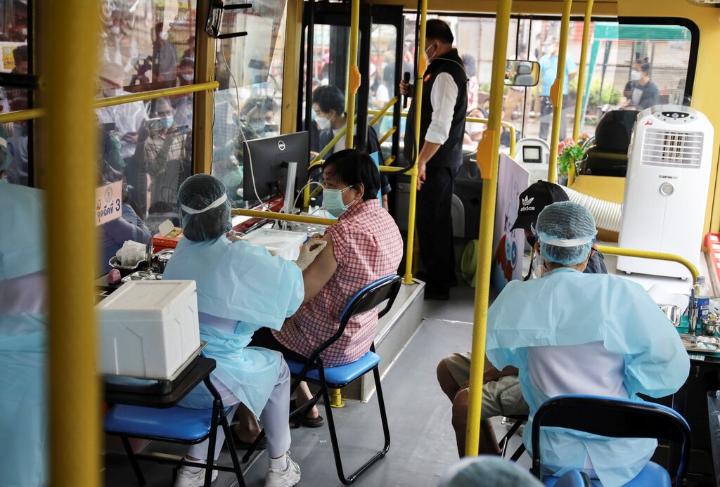 A woman receives a jab of the coronavirus disease (COVID-19) vaccine inside a mobile vaccination bus set-up to serve the elderly and disabled groups in Bangkok, Thailand, September 8, 2021. REUTERS/Juarawee Kittisilpa - RC2LLP9QYVEC
