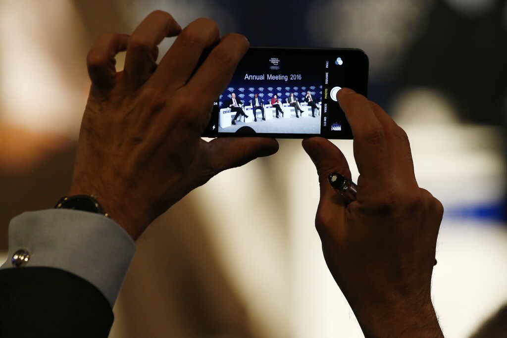 A participant takes a picture during the annual meeting of the World Economic Forum (WEF) in Davos, Switzerland January 22, 2016.