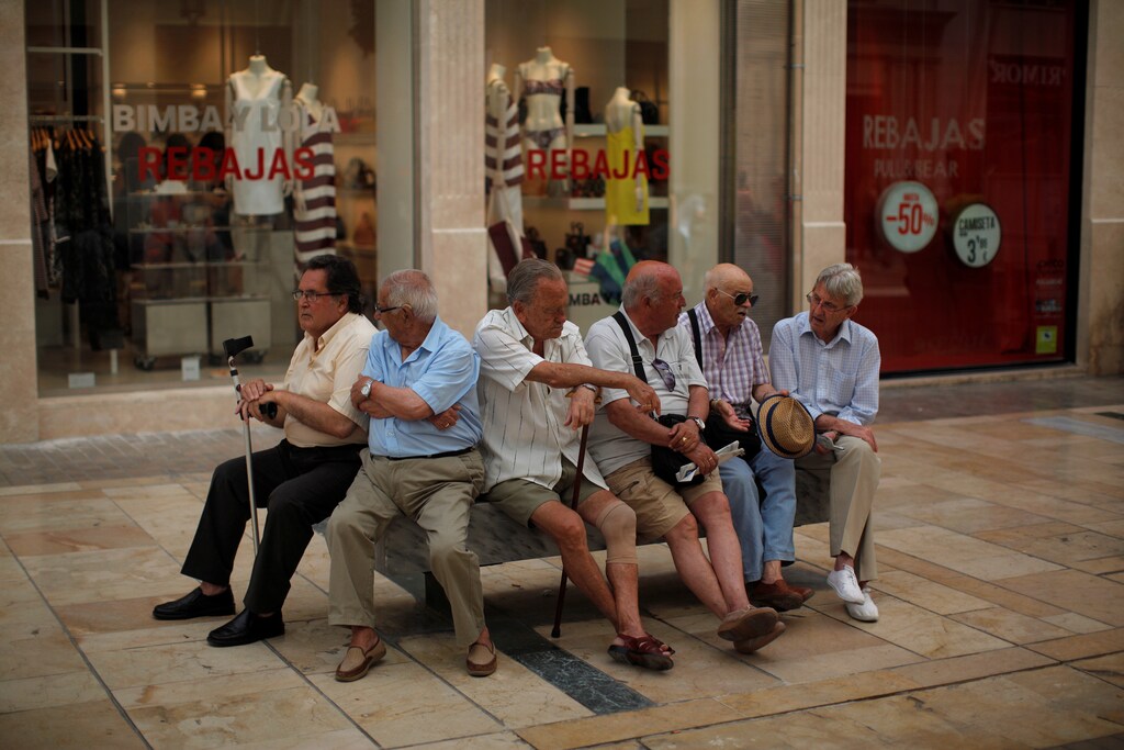 Pensioners sit on a bench at Marques de Larios street in downtown Malaga, Spain, July 4, 2016. REUTERS/Jon Nazca - S1AETNROHLAB