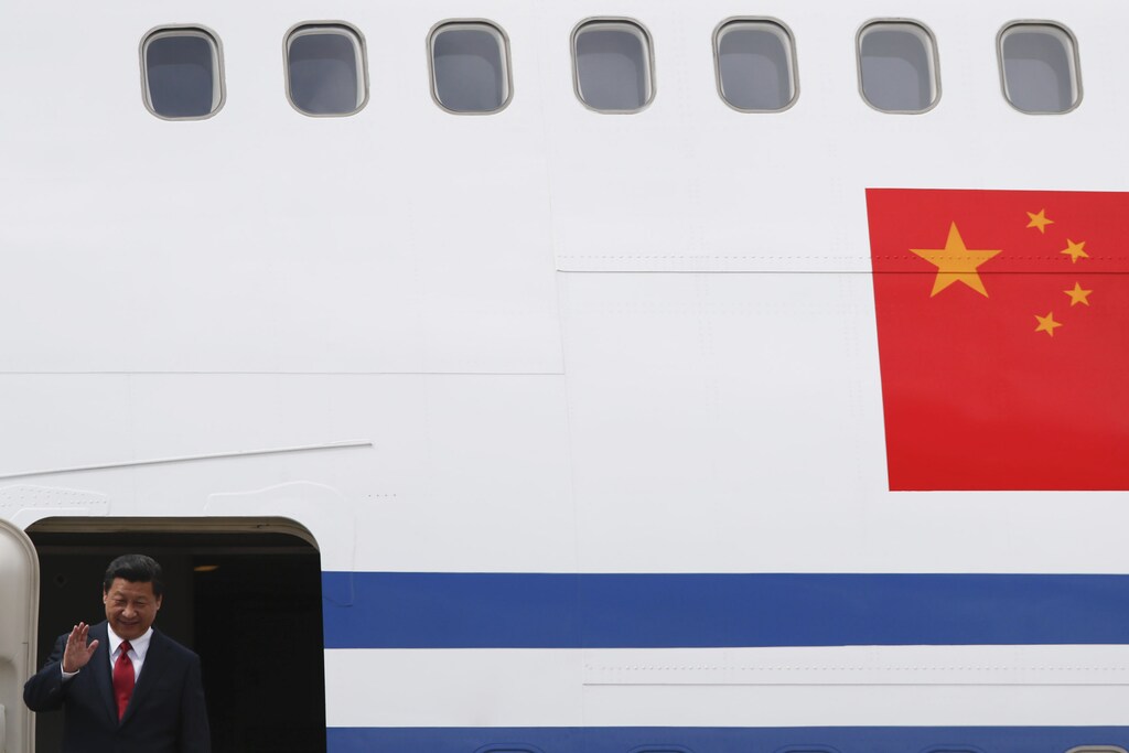 China's President Xi Jinping waves from his plane as he arrives in Venezuela, at Simon Bolivar airport in Caracas July 20, 2014. Xi is on a two-day official visit to Venezuela. REUTERS/Jorge Silva (VENEZUELA - Tags: TPX IMAGES OF THE DAY POLITICS) - RTR3ZFXJ