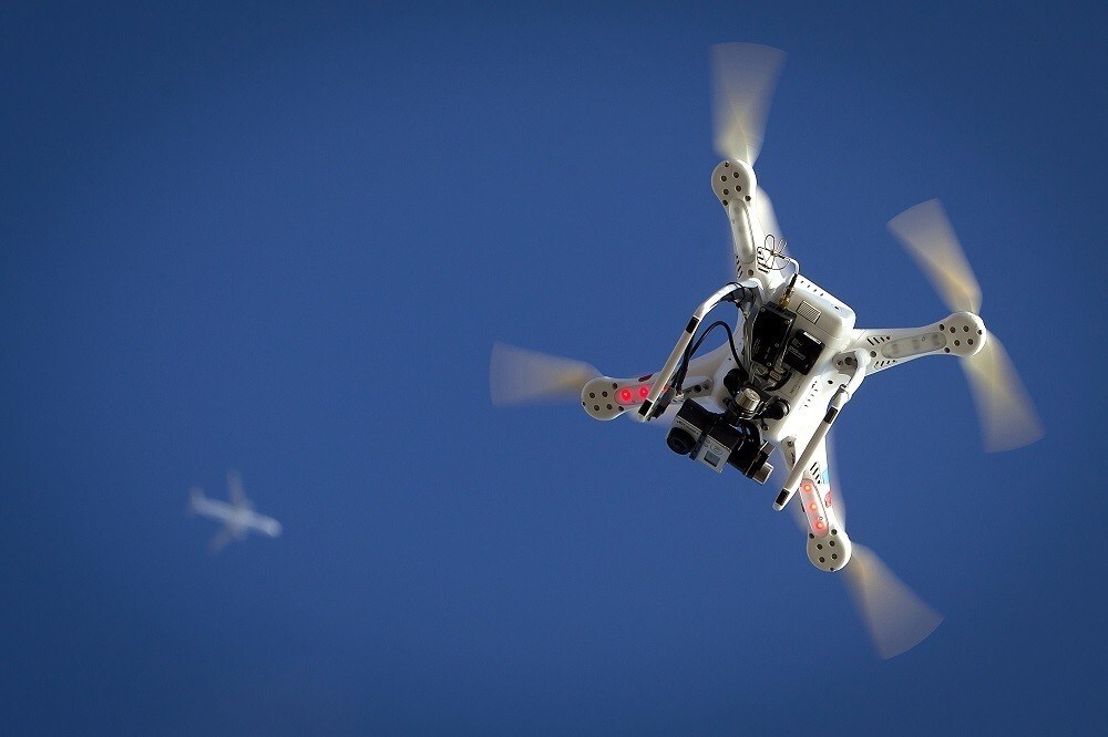 An airplane flies over a drone during the Polar Bear Plunge on Coney Island in the Brooklyn borough of New York January 1, 2015. The Coney Island Polar Bear Club is one of the oldest winter bathing organizations in the United States and holds a New Year's Day plunge every year. REUTERS/Carlo Allegri