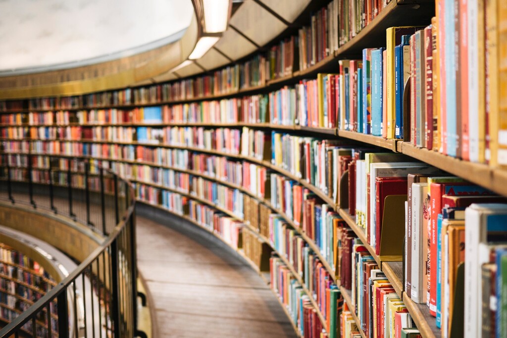 A row of books are seen at a public library.