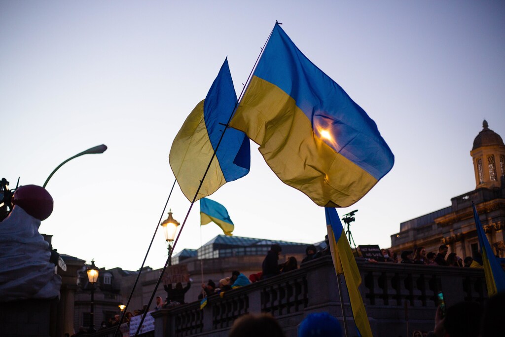 People holding up Ukraine flags in a city.