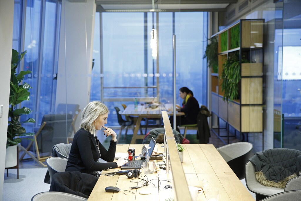 Workers sit at their desks at the Jellyfish office space in London, Britain December 19, 2016. Picture taken December 19, 2016. REUTERS/Neil Hall - LR1ECCM0ZHZIP