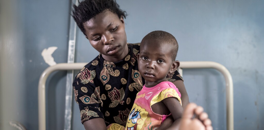 Mother and child getting treatment for malaria in a health care facility in Kisumu, Kenya.
