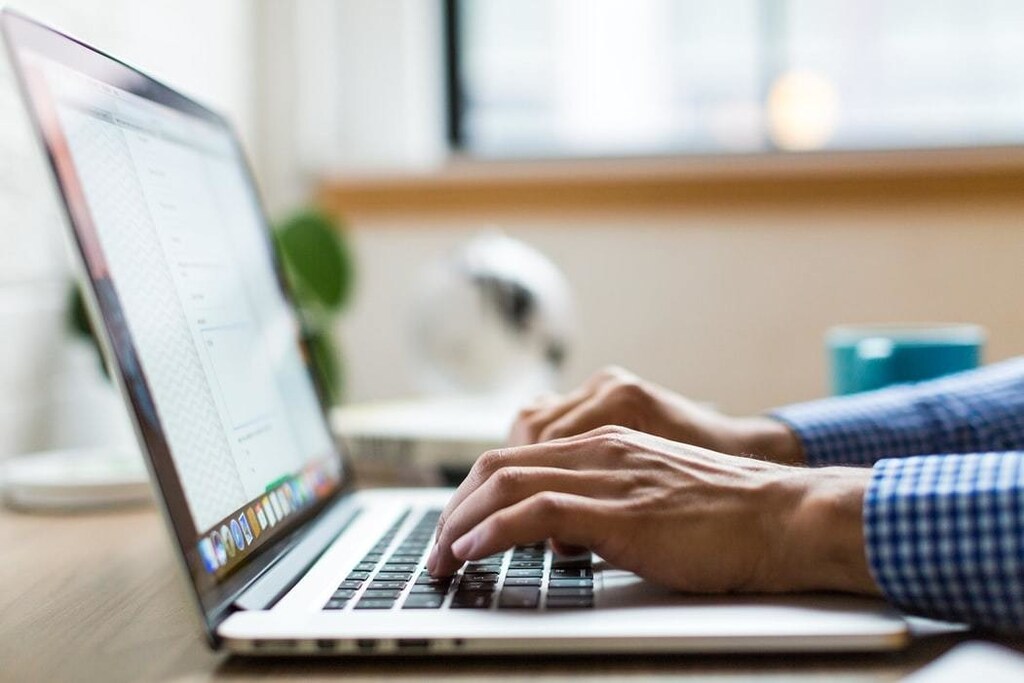Image of a man working on a laptop