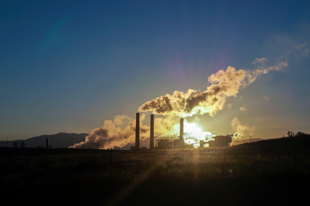 Smoke stacks as sun downs: Phasing out fossil fuels is one of five urgent actions the European Union must take to get back on track to meet climate targets.
