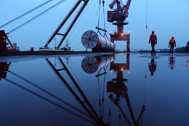 Workers are seen near a crane lifting offshore wind energy equipment by China Construction Industrial and Energy Engineering Group Co at a port in Nanjing, Jiangsu province, China April 23, 2019. Picture take April 23, 2019. ATTENTION EDITORS - THIS IMAGE WAS PROVIDED BY A THIRD PARTY. . - RC1AA7B1FC60
