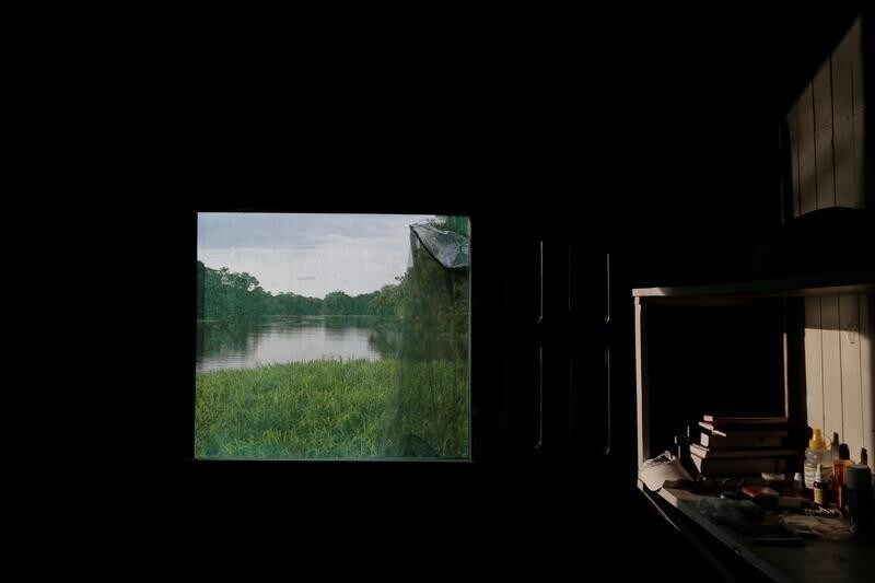 A window of the floating research base of the Mamiraua Institute looks out at the Mamiraua Sustainable Development Reserve in Uarini, Amazonas state, Brazil, February 27, 2018. REUTERS/Bruno Kelly SEARCH "JAGUARS AMAZON" FOR THIS STORY. SEARCH "WIDER IMAGE" FOR ALL STORIES. - RC161B5E3410