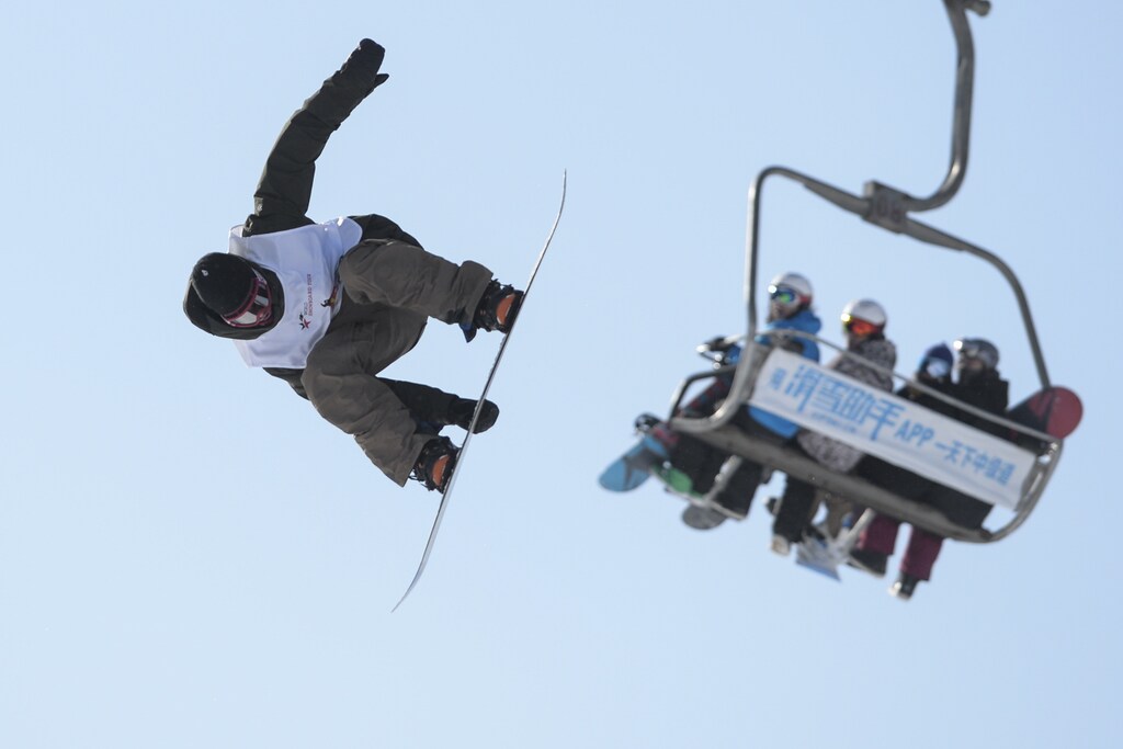 A snowboarding contestant takes a jump during a competition in Beijing, China, January 17, 2016. REUTERS/China Daily ATTENTION EDITORS - THIS PICTURE WAS PROVIDED BY A THIRD PARTY. THIS PICTURE IS DISTRIBUTED EXACTLY AS RECEIVED BY REUTERS, AS A SERVICE TO CLIENTS. CHINA OUT. NO COMMERCIAL OR EDITORIAL SALES IN CHINA. - GF20000098599